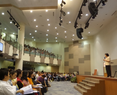 A speaker addressing a big audience